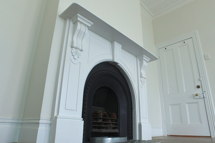 White fireplace and white villa door with brass handle
