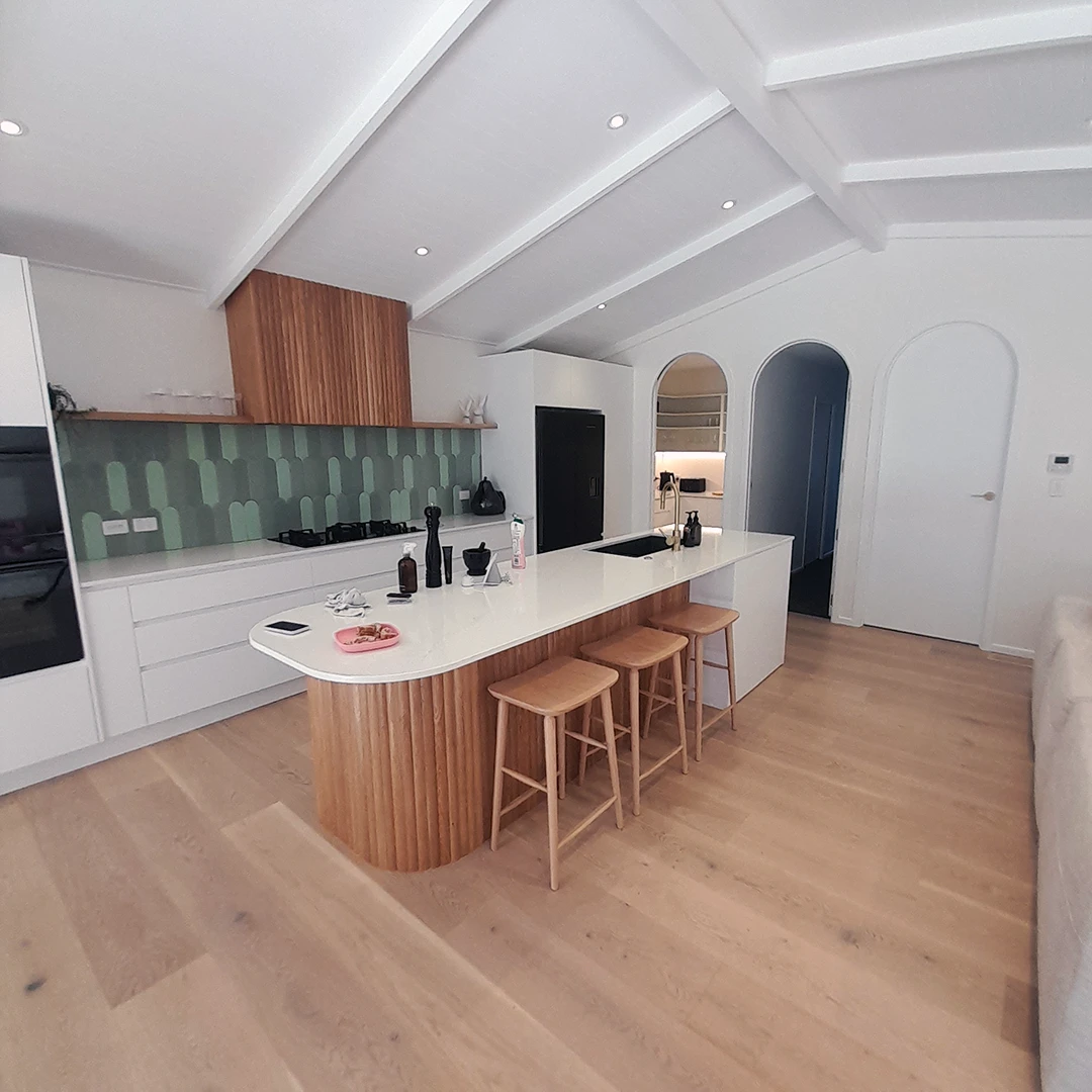 A kitchen with a bar and counter, providing a functional and stylish space for cooking and dining.