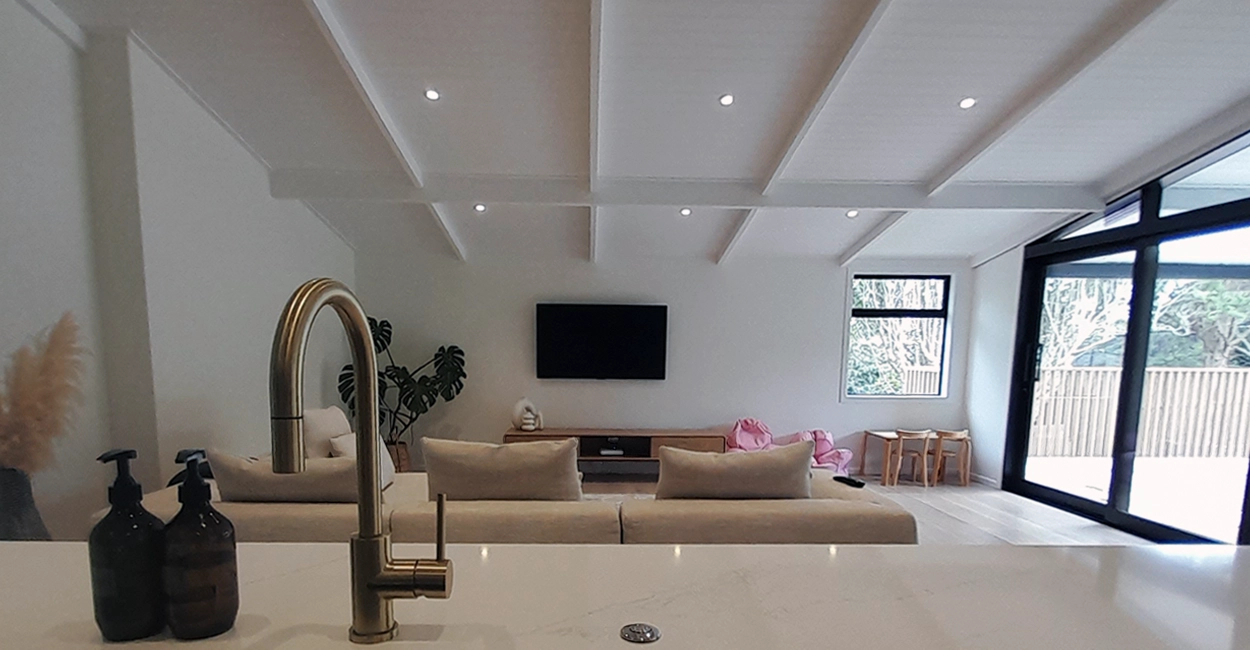 A kitchen with a bar and counter, providing a functional and stylish space for cooking and dining.